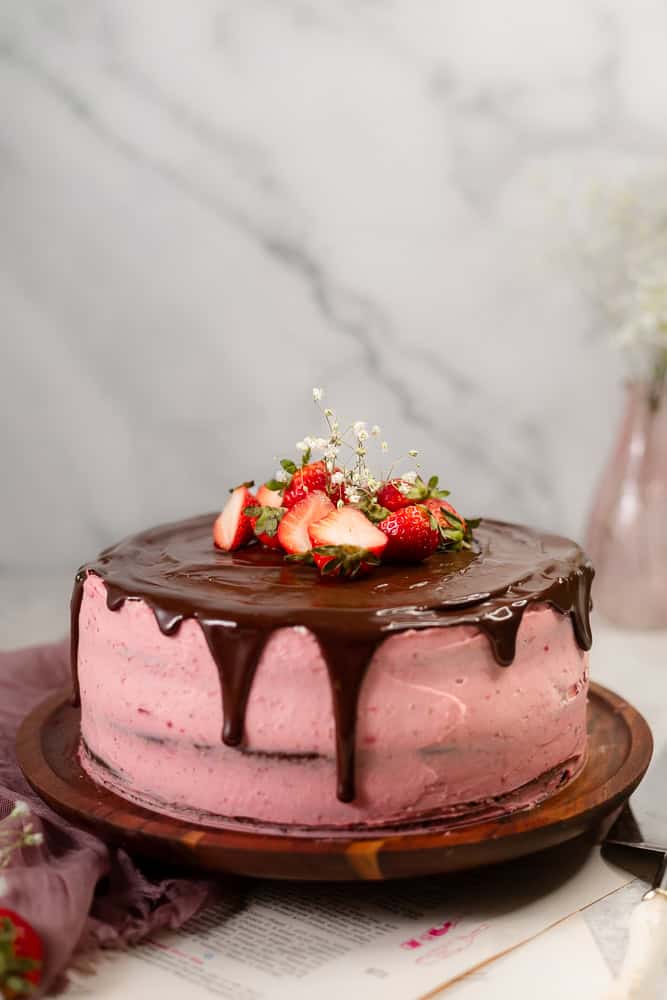 cake with chocolate drip and strawberry filling