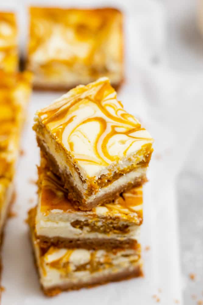 stack of cheesecake bars with pumpkin